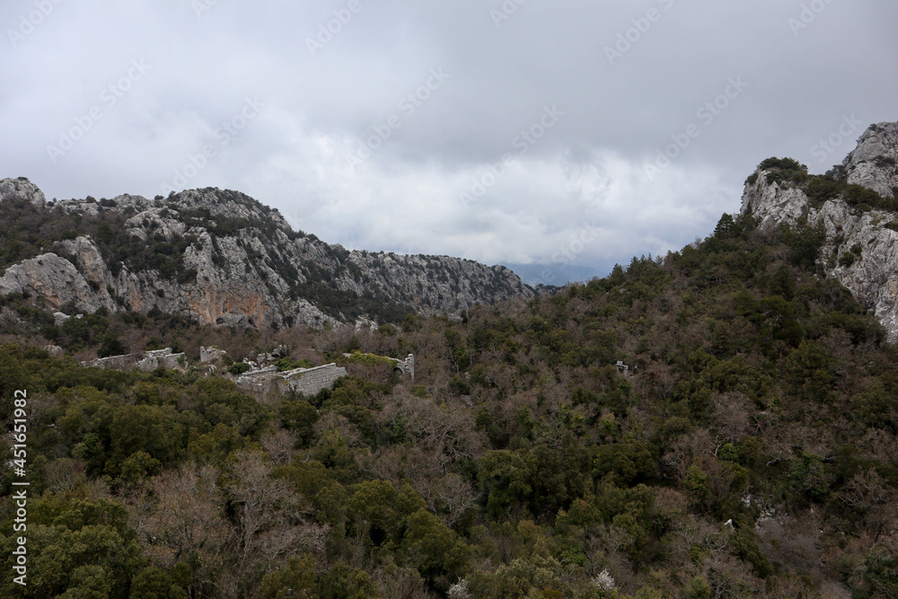 panoramic view from the top of the mountain to the ruins of ancient abandoned city Termessos in Turkey