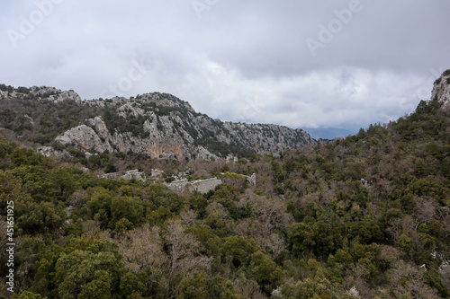 panoramic view from the top of the mountain to the ruins of ancient abandoned city Termessos in Turkey