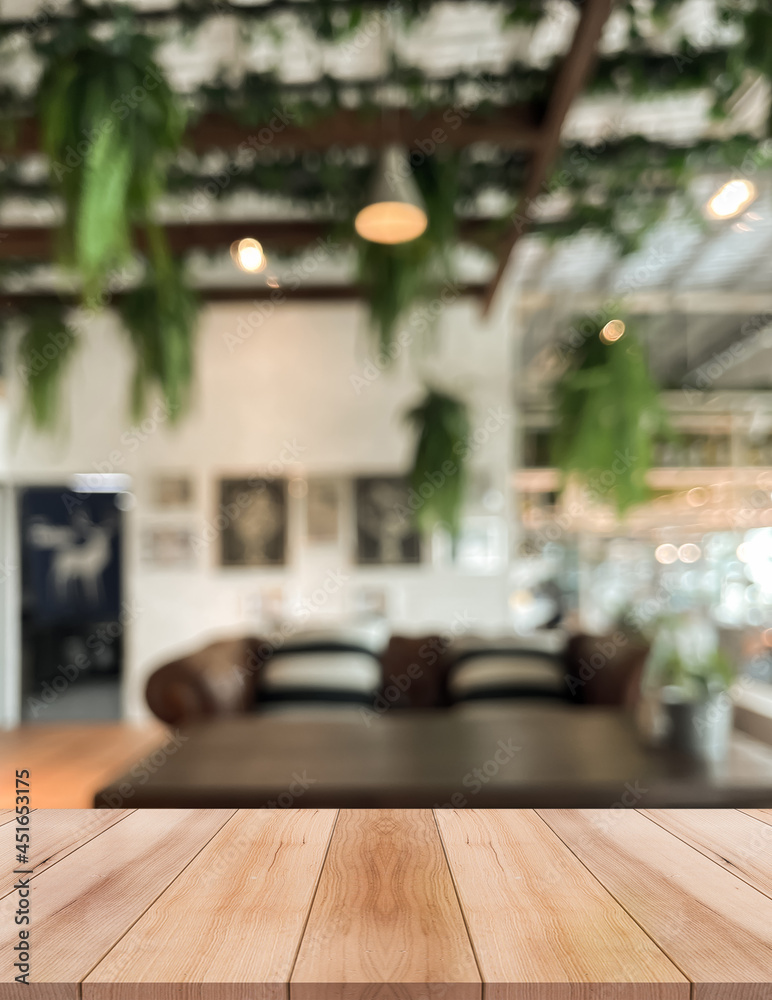 Empty wooden table top with lights bokeh on blur restaurant background. Empty wooden table top with lights bokeh on blur restaurant background.