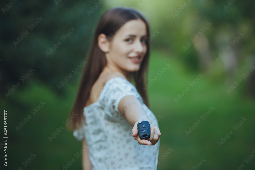 Young beautiful girl holding car keys in hand