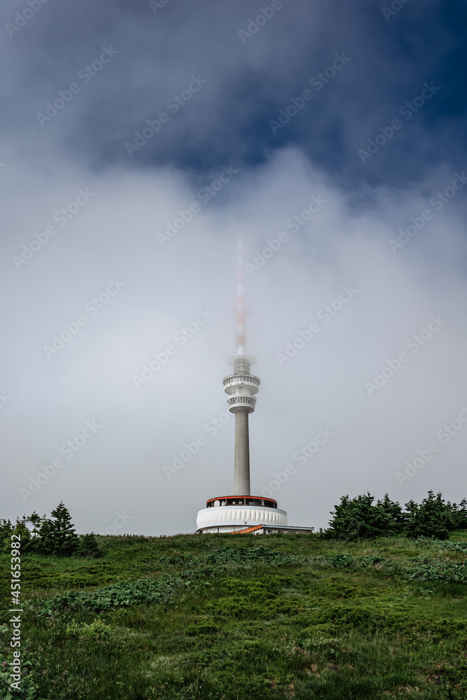 Television transmitter tower with observation platform on foggy peak of Praded,Jeseniky mountains,Czech republic.Views of picturesque countryside,popular tourist place for hiking and leisure.Misty day