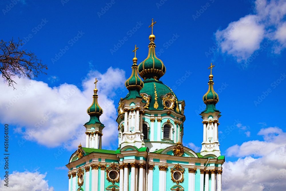 Scenic landscape view of ancient Saint Andrew's Church against blue sky with white clouds at sunny day. Designed by architect Bartolomeo Rastrelli in Baroque style. Sacred christian building