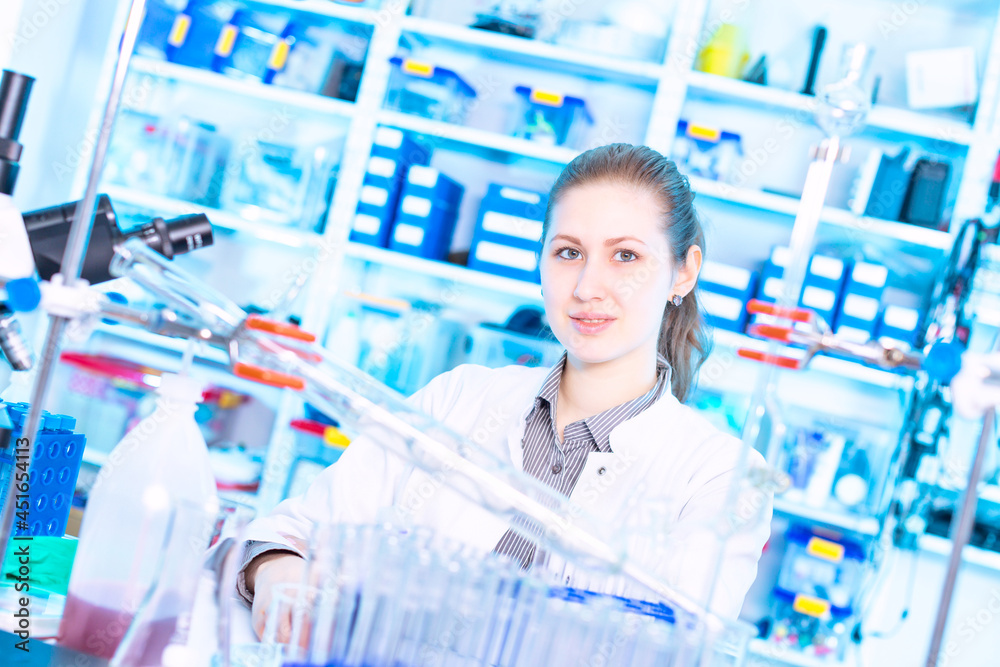 Young female student at university chemistry laboratory smiling and posing at camera Young female student at university chemistry laboratory smiling and posing at camera