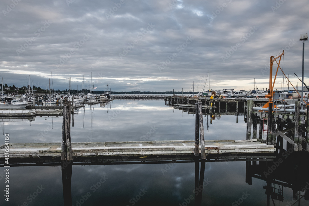 Fototapeta premium Clouds reflecting on the water at Blaine Harbor in Blaine, Washington