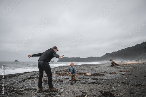 Father playing with son on Rialto Beach in Olympic National Park