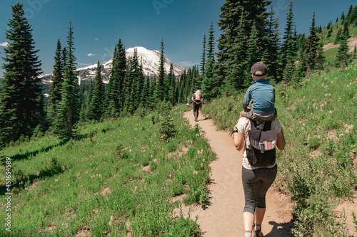 Young family hiking toward Mt Rainier on the Naches Peak Loop Trail in Mt. Rainier National Park photo