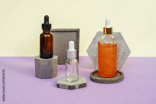 Front view of different face serum bottles.