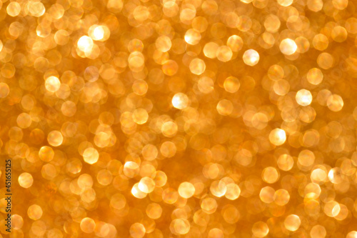yellow sparkle glitter background. Holiday abstract defocused background.