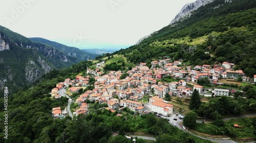 Flight over Italian village in the mountains photo