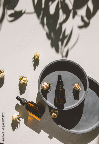 A bottle of hyaluronic acid with a pipette on a concrete background. Top view