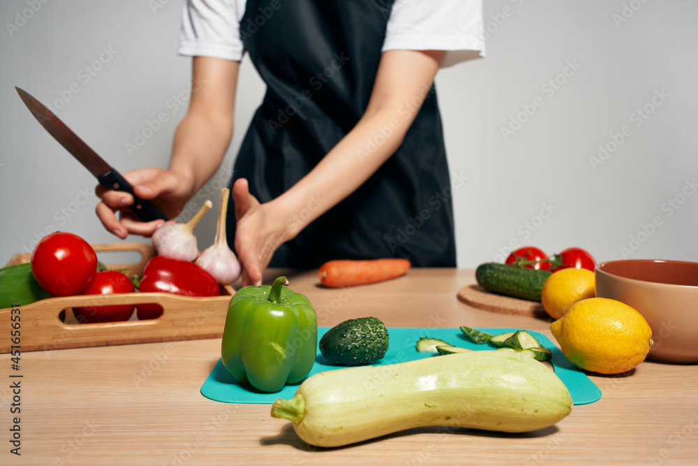 Woman in black apron Cooking healthy eating isolated background Woman in black apron Cooking healthy eating isolated background