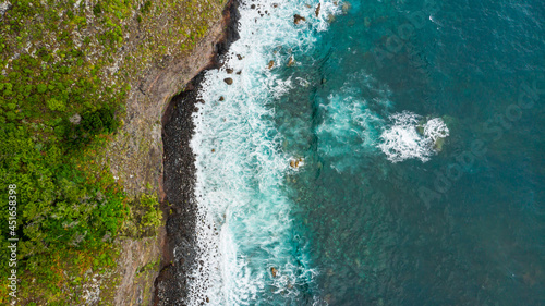 Amazing aerial view of crashing waves on rocks seascape.