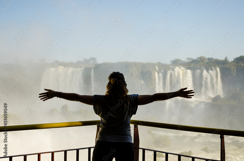 Fototapeta premium person standing on a bridge in the iguazu waterfalls