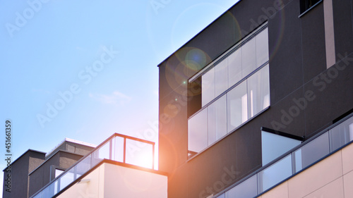 Modern apartment building on a sunny day with a blue sky. Facade of a modern apartment building.Glass surface with sunlight.