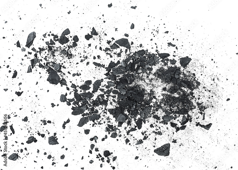 Black dust powder of charcoal on a white background, top view. Charcoal dust with fragments. Black dust powder of charcoal on a white background, top view. Charcoal dust with fragments.