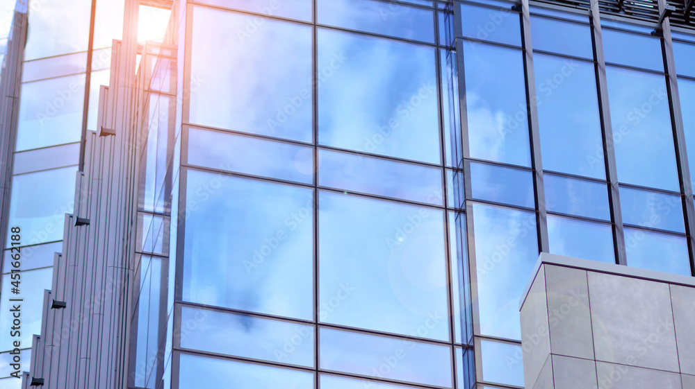 A beautiful background of an glass office building, reflecting blue sky in the windows. A beautiful background of an glass office building, reflecting blue sky in the windows.