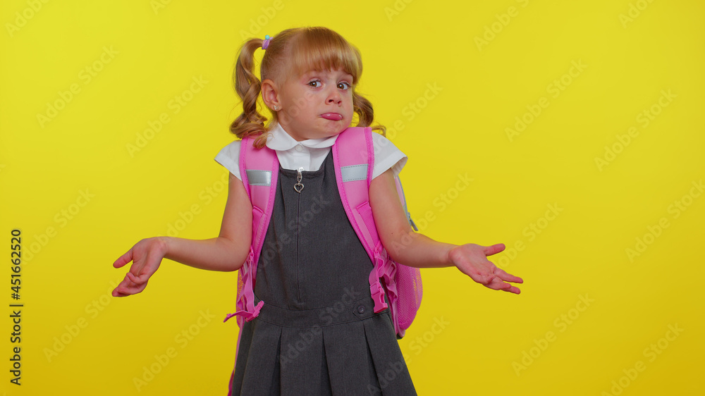 I dont know what to say. Confused schoolgirl with backpack feeling embarrassed about ambiguous question, having doubts, no idea, being clueless and uncertain. Yellow wall background. Back to school I dont know what to say. Confused schoolgirl with backpack feeling embarrassed about ambiguous question, having doubts, no idea, being clueless and uncertain. Yellow wall background. Back to school