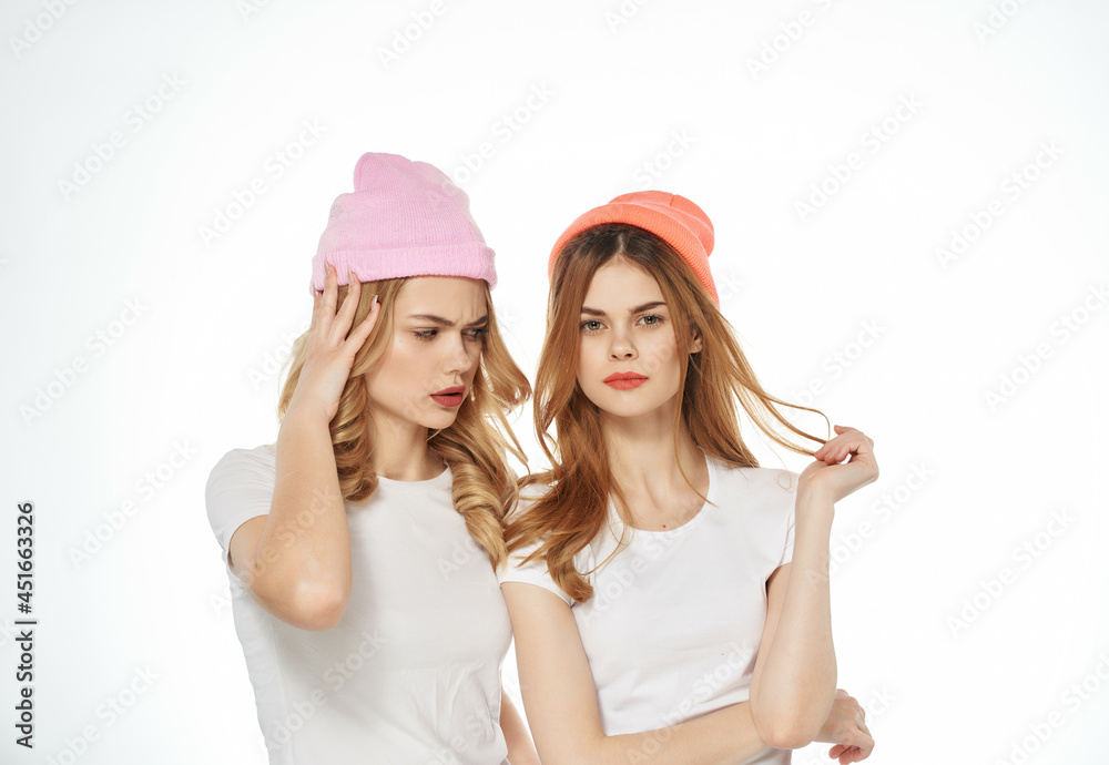two women stand side by side in white t-shirts fashion friendship lifestyle two women stand side by side in white t-shirts fashion friendship lifestyle