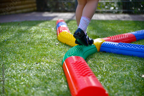 Child balancing on a balance beam in the garden. photo