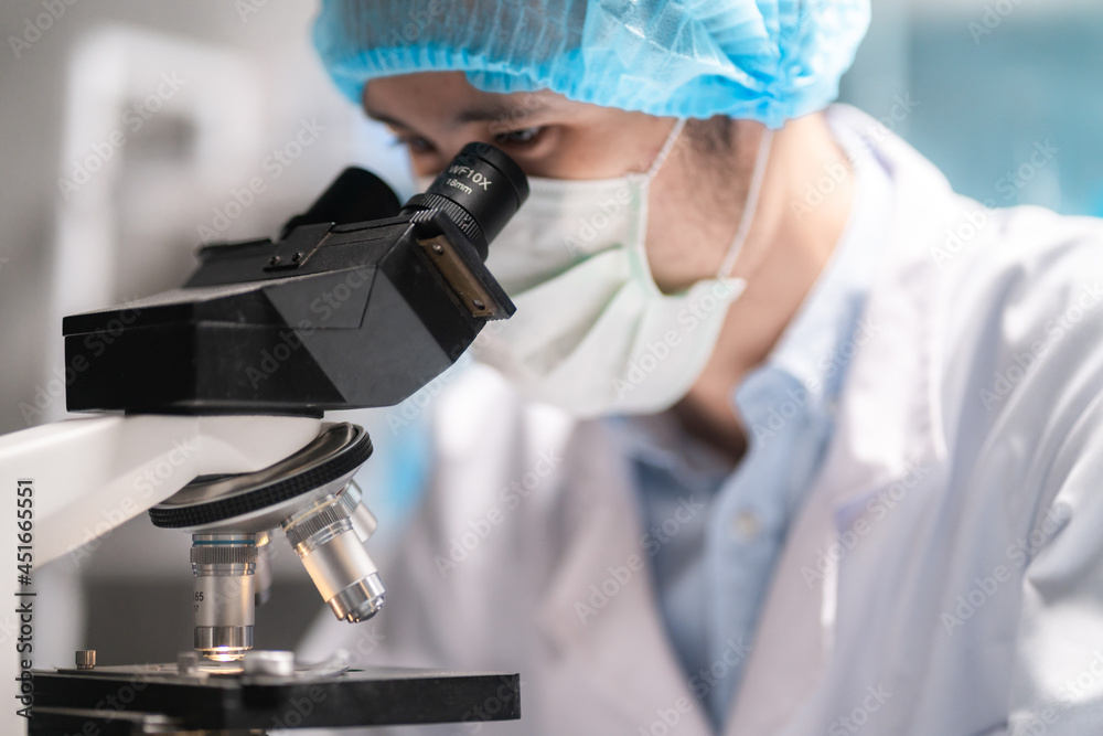 microscope in a medical research lab or science laboratory, study for making vaccine to protection a coronavirus COVID-19