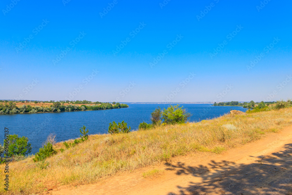 Summer landscape with beautiful river, green trees and blue sky