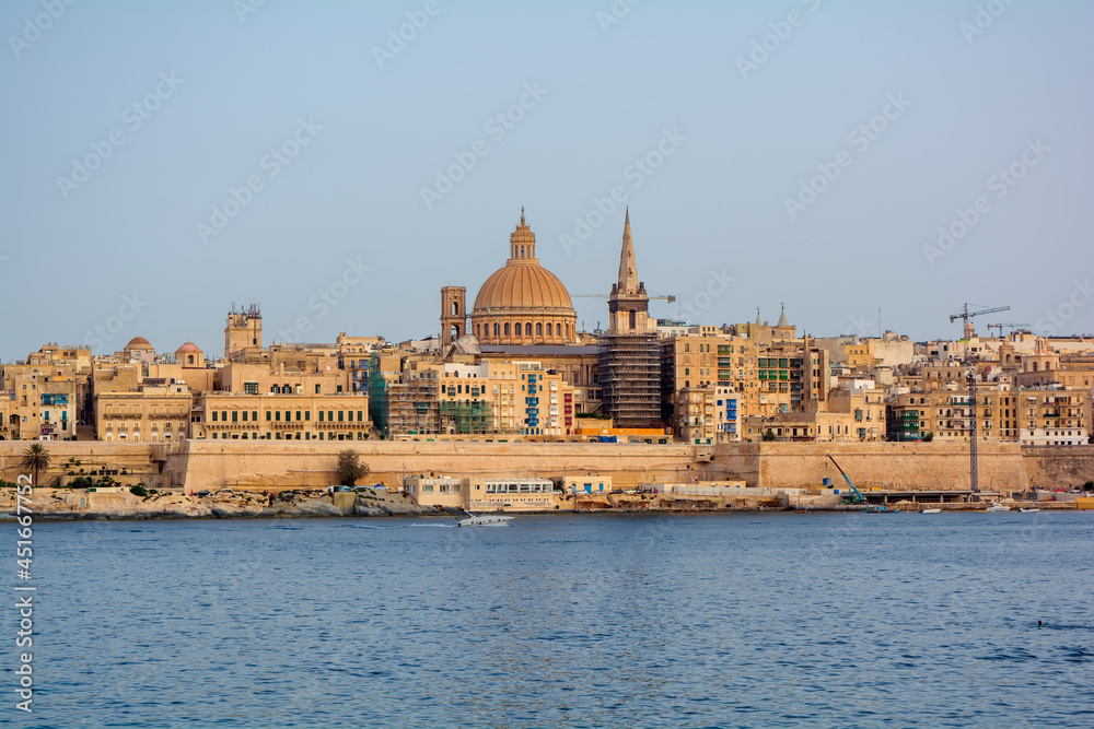Coastal landscape of Valletta at sunny summer day. Maltese Valletta skyline with church of Our Lady of Mount Carmel and St Paul's Pro-Cathedral.
