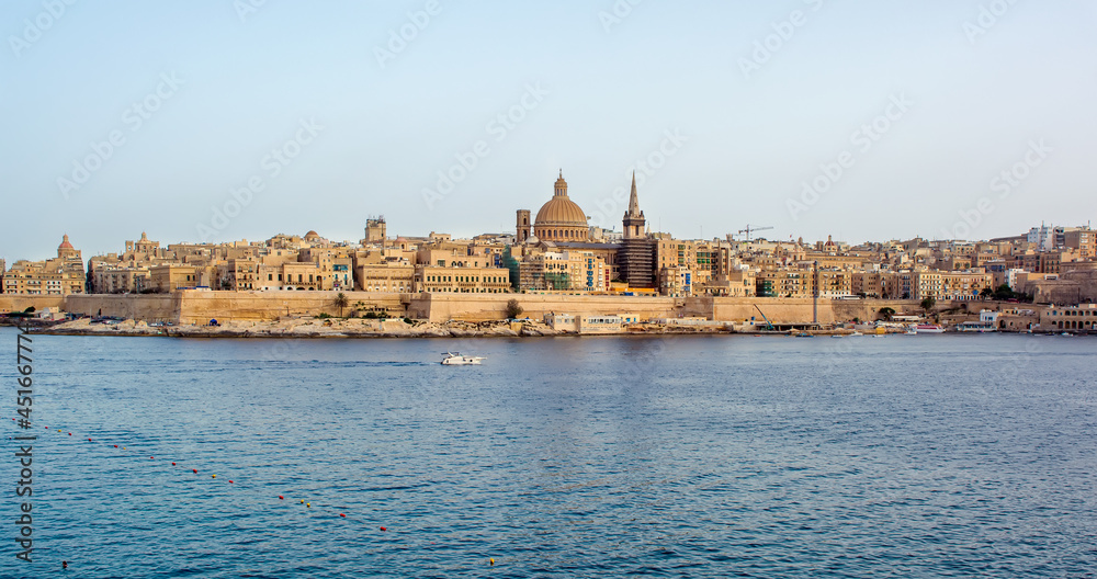 Coastal landscape of Valletta at sunny summer day. Maltese Valletta skyline with church of Our Lady of Mount Carmel and St Paul's Pro-Cathedral.