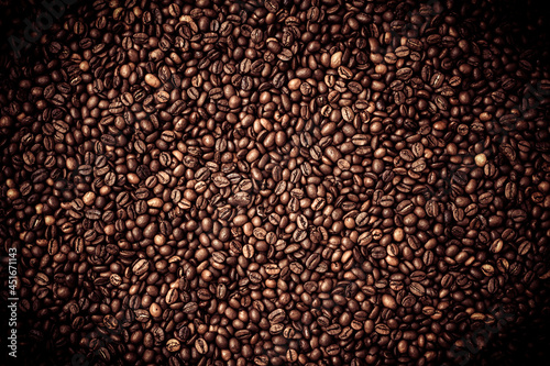 Сalibrated Arabica сoffee beans poured into a solid layer on a surface table, blended, background, top view