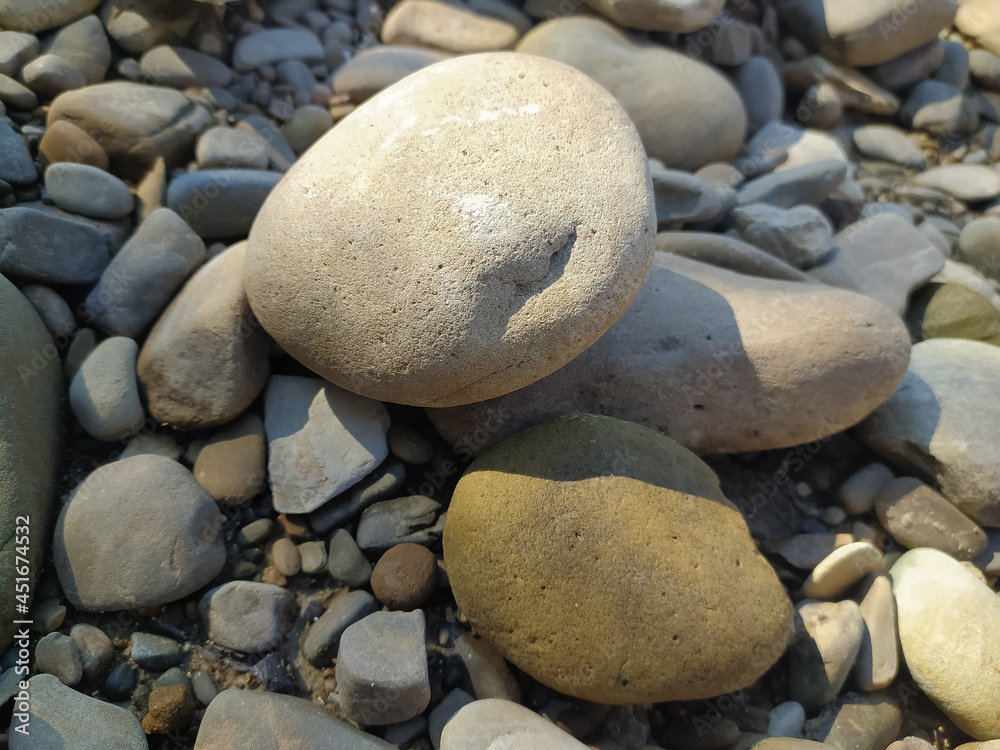Stones on a pebble beach. Beach stones. Pebbles located on the beach. Stones on a pebble beach. Beach stones. Pebbles located on the beach.