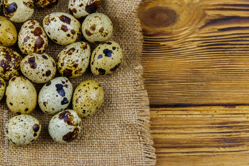 Quail eggs on a wooden table. Top view