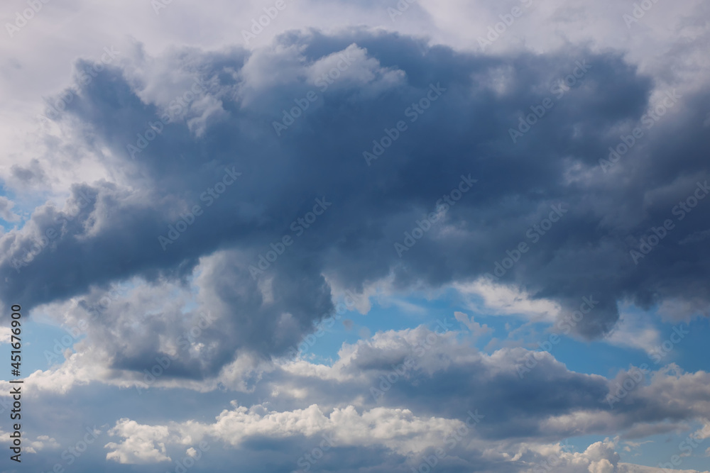 Blue sky with fluffy clouds. Colorful cloudscape background.