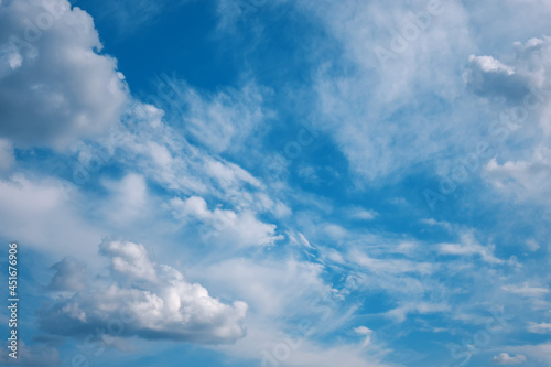 Blue sky and white fluffy clouds. Natural cloudscape background.