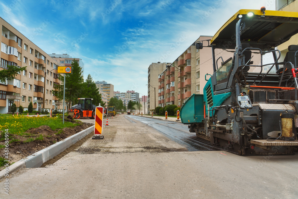 Fototapeta premium Road paving machine working on the street.