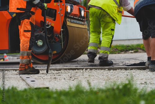 Road reconstruction. Heavy vibration road roller stacking hot asphalt.