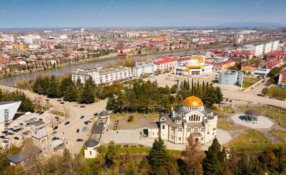 Scenic aerial view of Black Sea coastal city of Poti on banks of Rioni river overlooking golden domed Orthodox Cathedral on sunny spring day, Georgia.