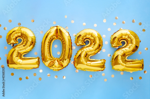 2022 Happy New year eve invitation with Christmas gold foil balloons calendar. 2022 numeral balloon gold text on Blue background with golden confetti for New year celebration