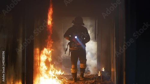 Fireman examining burning corridor during rescue mission