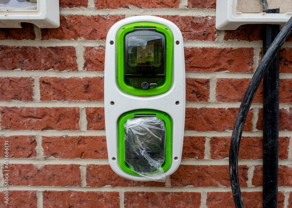 Electric vehicle domestic charging point installed outside of the house on new housing