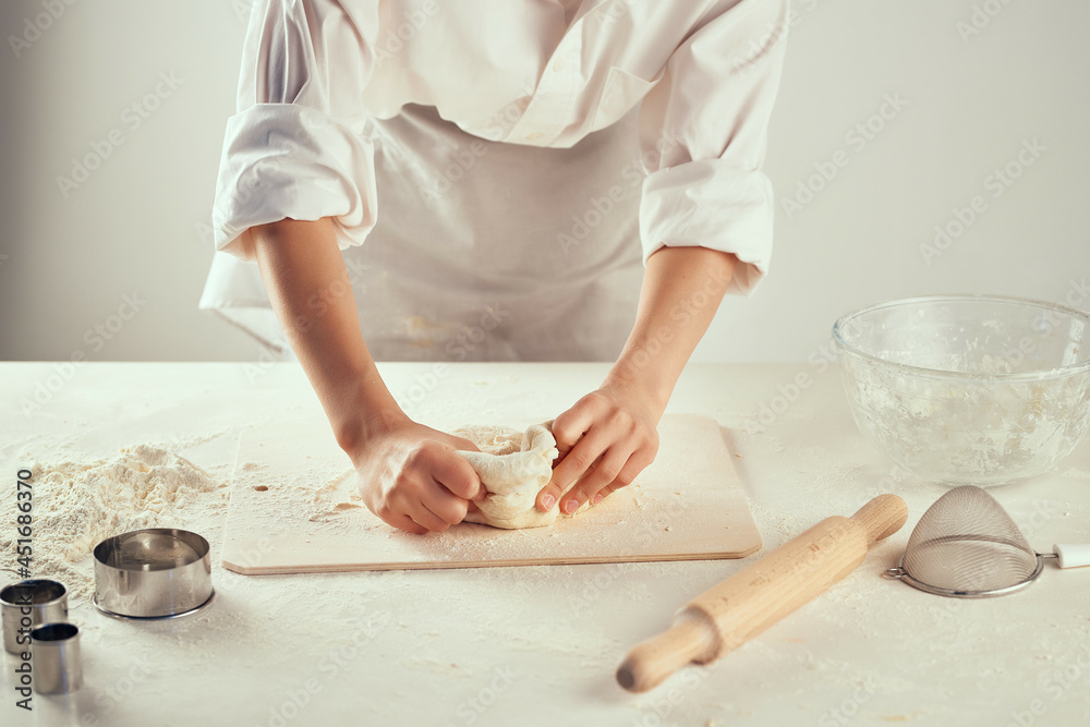 Fototapeta premium the cook rolls the dough pastry chef diy flour