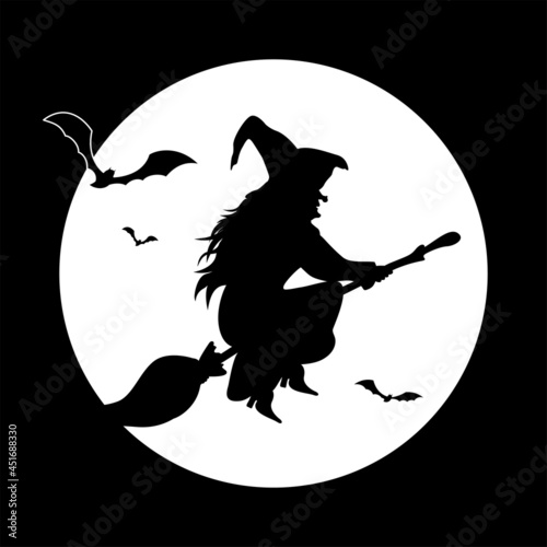 Silhouette of a witch on a broom against the background of a full moon.