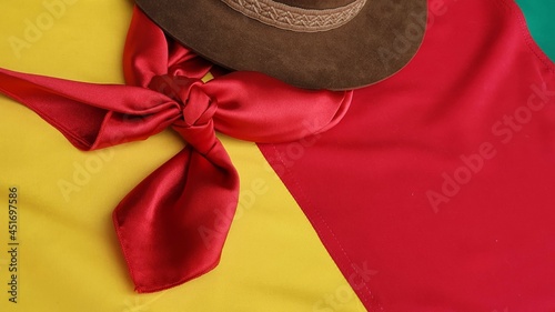 Hat, red gaucho scarf and State Flag of Rio Grande do Sul - Brazil, on the table. Decoration to commemorate the traditional Week in southern Brazil. Farroupilha from the Gauchos. photo