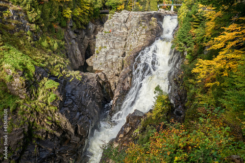 Saint Anne Falls, locally known as Chute Saint-Anne, cascades down a rocky cliff surrounded by the forested walls of the canyon.