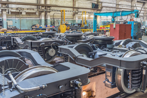Several railway wheels inside the plant building.
