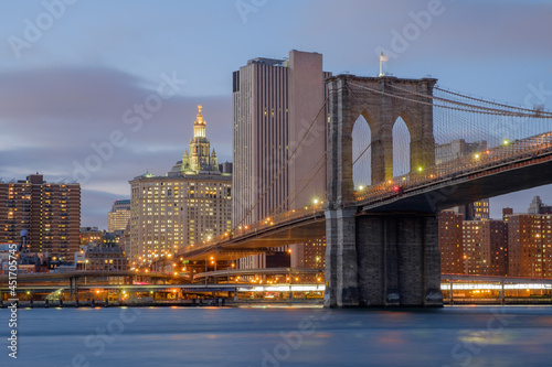 Brooklyn Bridge spanning the East River from Brooklyn into New York City at sundown