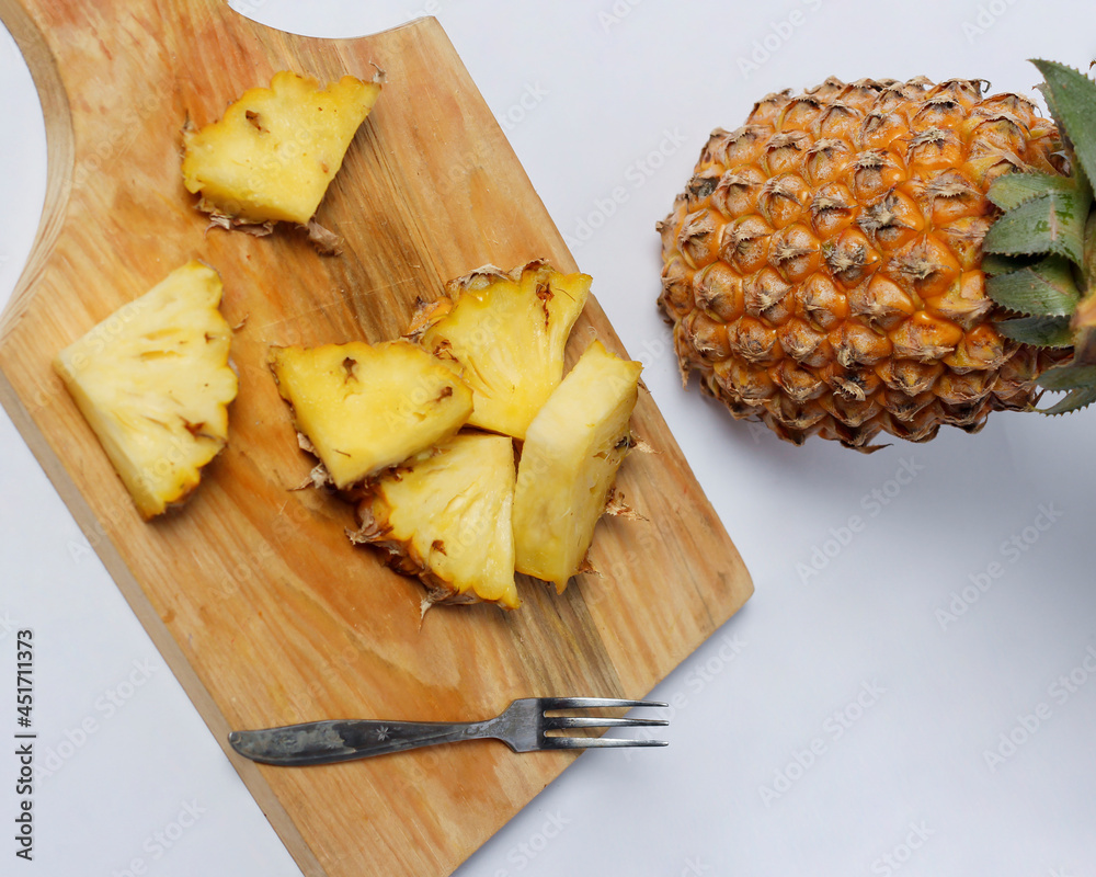 Whole pineapple isolated on a bright background. Close-up view of fresh and delicious pineapple. Overripe pineapples that begin to rot will release a sweet, honey-like liquid. Focus blur. Pineapple mo Whole pineapple isolated on a bright background. Close-up view of fresh and delicious pineapple. Overripe pineapples that begin to rot will release a sweet, honey-like liquid. Focus blur. Pineapple mo