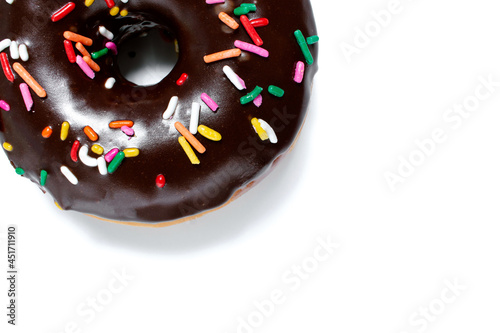 Close up of a chocolate frosted donut with rainbow sprinkles