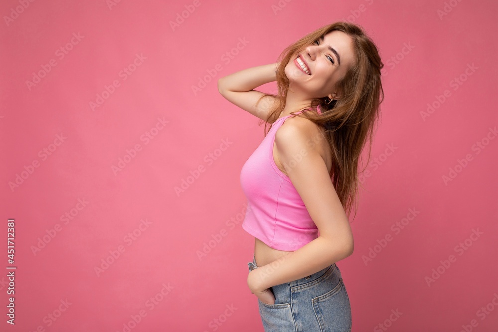 Photo of attractive cute happy emotional young woman poising isolated on background wall with free space wearing trendy casual clothes Photo of attractive cute happy emotional young woman poising isolated on background wall with free space wearing trendy casual clothes