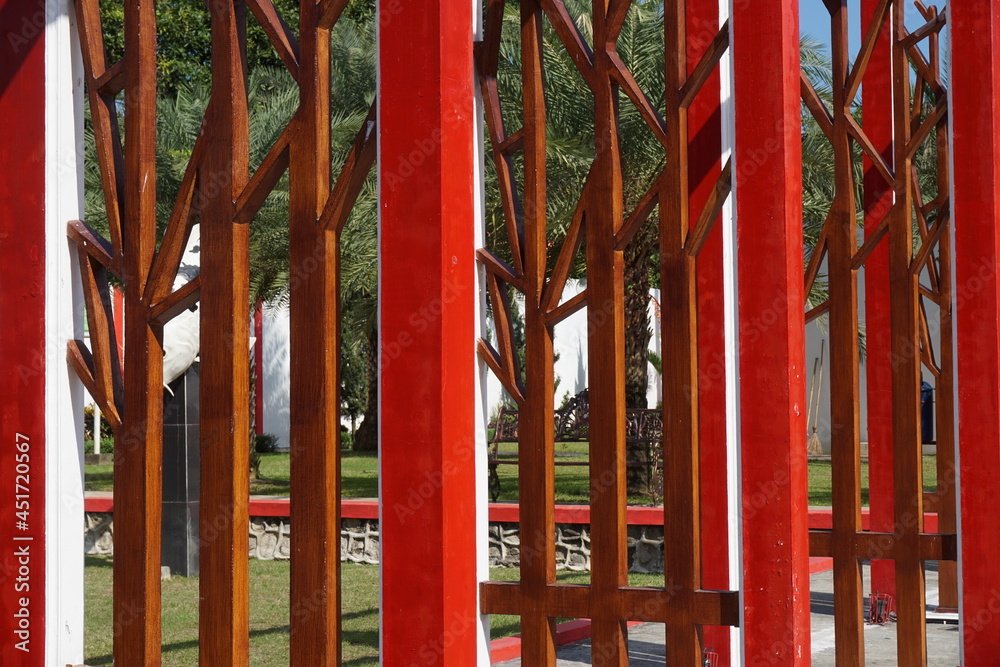 Modern red fence with a natural background