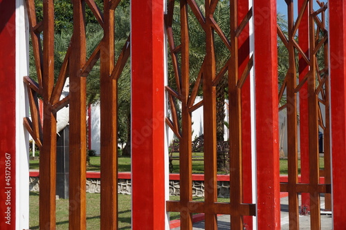 Modern red fence with a natural background