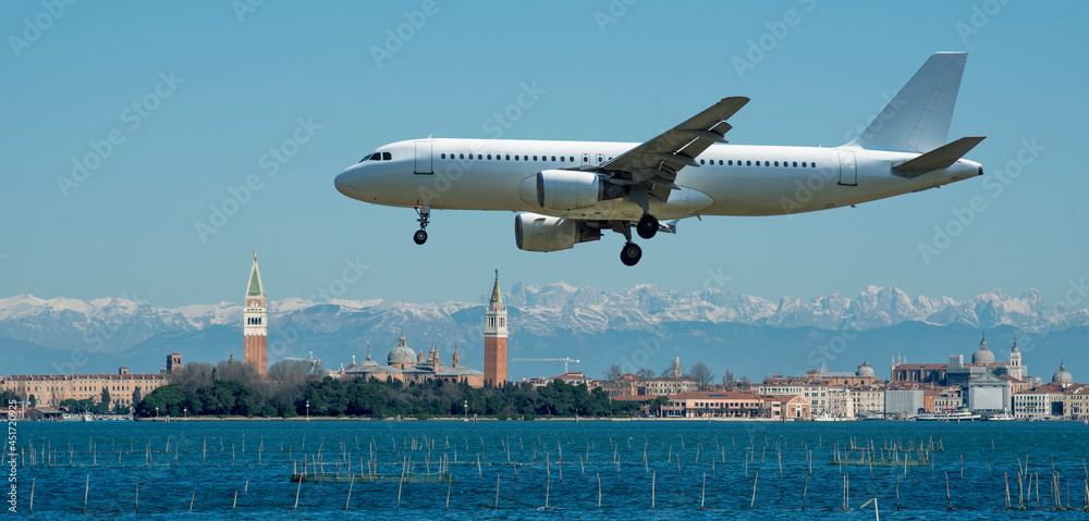 plane at take off flies over the city of Venice in Italy